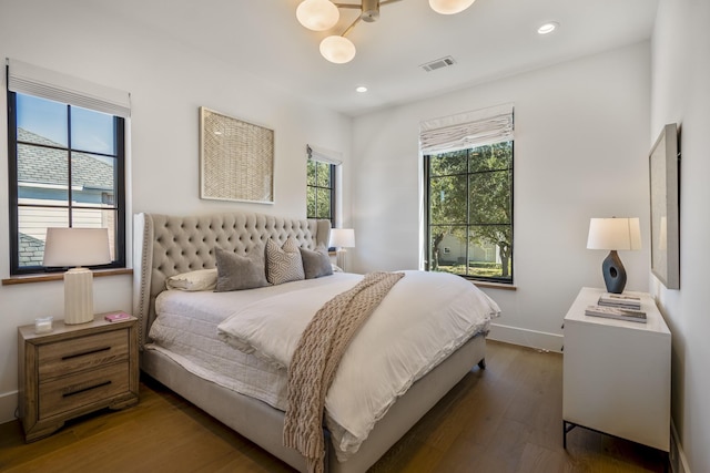 bedroom featuring baseboards, visible vents, wood finished floors, and recessed lighting