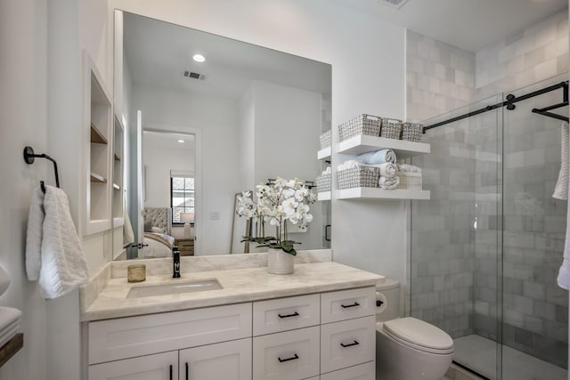 bathroom featuring vanity, connected bathroom, toilet, and a shower stall