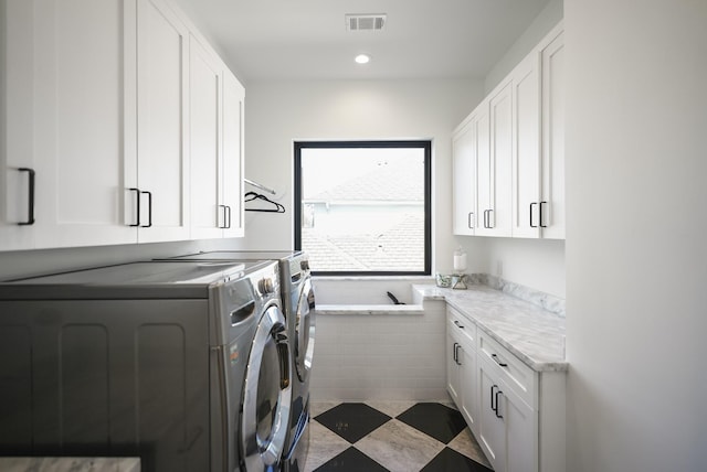 washroom with recessed lighting, visible vents, cabinet space, and washing machine and clothes dryer