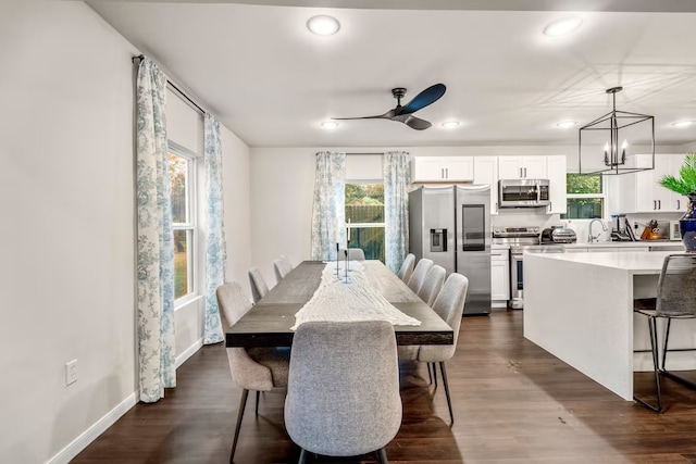 dining space with recessed lighting, dark wood-style flooring, and ceiling fan with notable chandelier