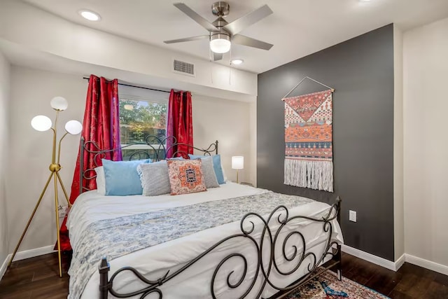 bedroom with dark wood-type flooring, visible vents, and baseboards