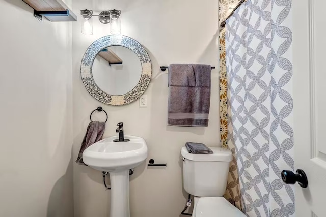 bathroom with toilet and a sink