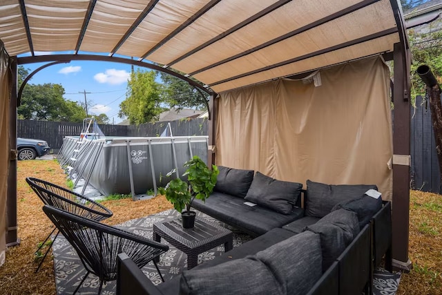 view of patio / terrace featuring a fenced in pool, fence, and an outdoor hangout area