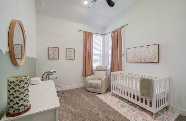 bedroom featuring baseboards, lofted ceiling, ceiling fan, carpet floors, and a nursery area