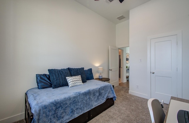 bedroom with high vaulted ceiling, baseboards, visible vents, and carpet flooring