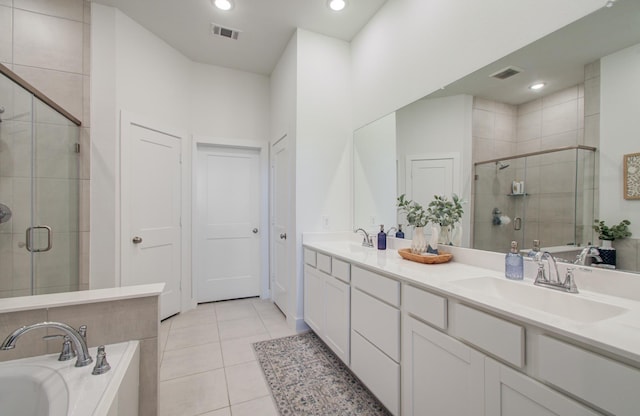 bathroom featuring tile patterned flooring, a sink, visible vents, a shower stall, and double vanity