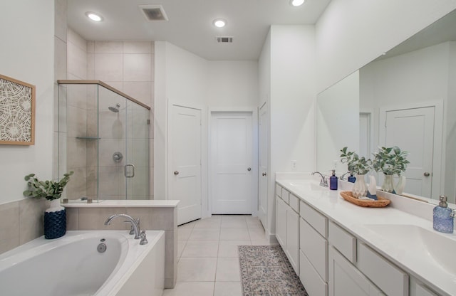 full bathroom featuring a stall shower, tile patterned flooring, visible vents, and a sink