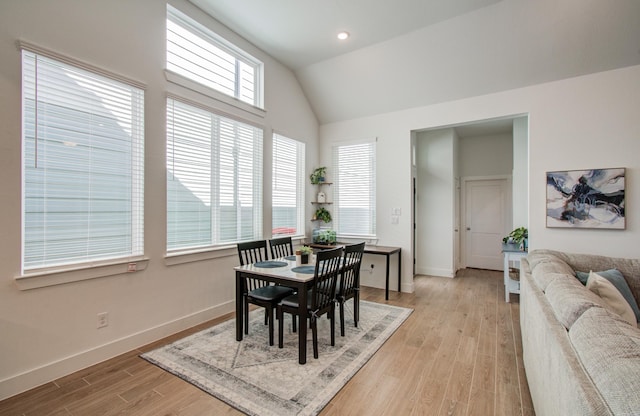 dining space with recessed lighting, baseboards, vaulted ceiling, and light wood finished floors