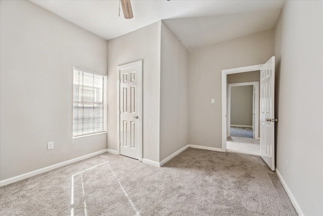 unfurnished bedroom featuring ceiling fan, carpet, and baseboards