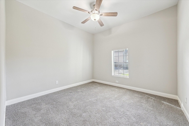 empty room with ceiling fan, carpet, and baseboards