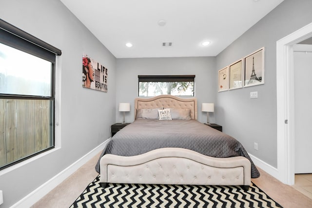 bedroom featuring recessed lighting, light colored carpet, visible vents, and baseboards