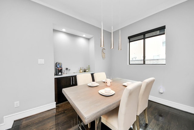 dining area with baseboards, dark wood-type flooring, and recessed lighting