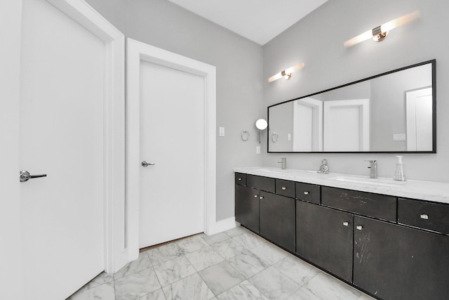 full bathroom featuring double vanity, marble finish floor, and a sink