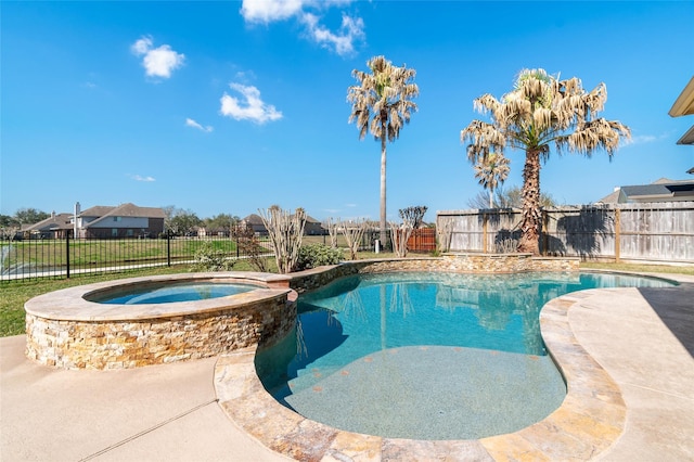 view of pool featuring a pool with connected hot tub and a fenced backyard