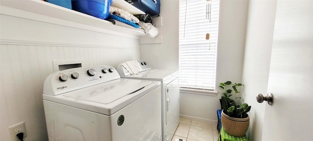 laundry room featuring laundry area, light tile patterned floors, and washing machine and clothes dryer