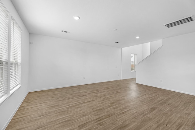 unfurnished living room featuring visible vents, wood finished floors, and recessed lighting