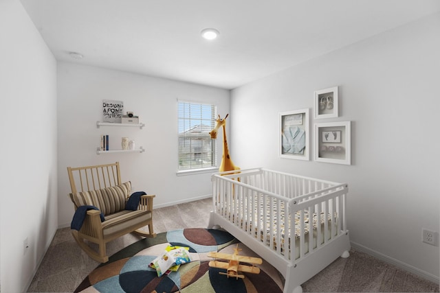 bedroom featuring light carpet and baseboards