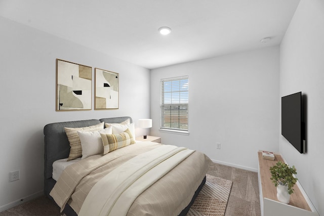 carpeted bedroom featuring baseboards