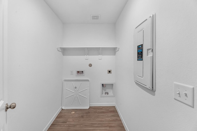 clothes washing area with baseboards, laundry area, wood finished floors, and hookup for an electric dryer