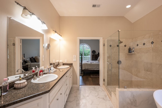 full bathroom featuring vaulted ceiling, connected bathroom, marble finish floor, and a sink