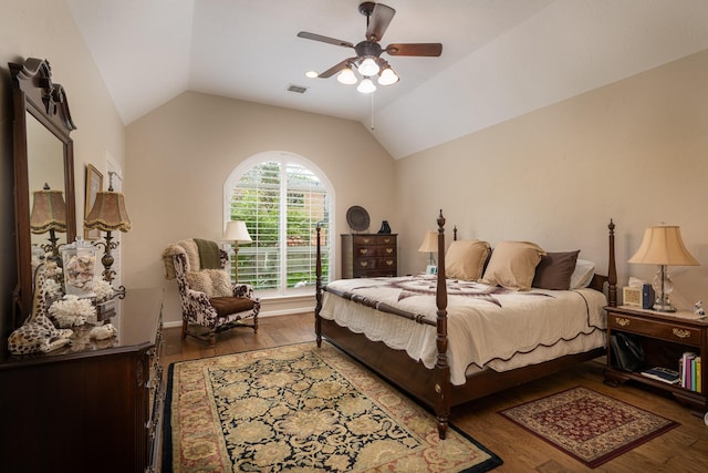 bedroom with lofted ceiling, a ceiling fan, visible vents, and wood finished floors