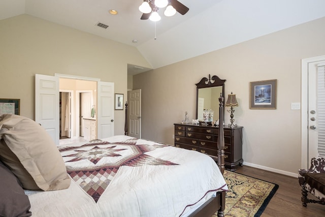 bedroom with lofted ceiling, wood finished floors, visible vents, and baseboards