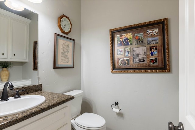 bathroom featuring toilet and vanity