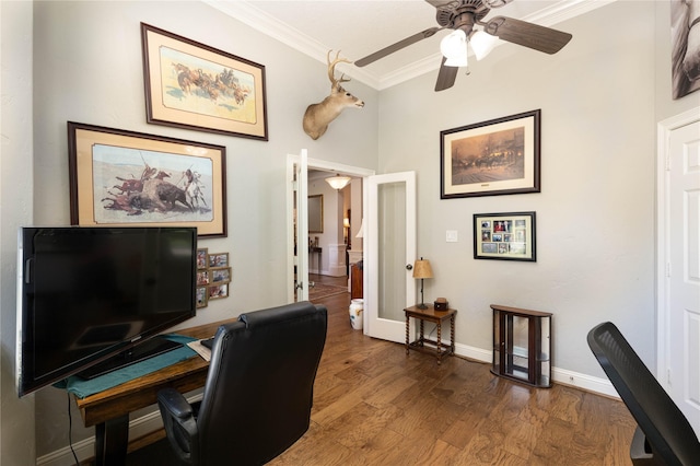 office space with baseboards, ornamental molding, ceiling fan, and wood finished floors