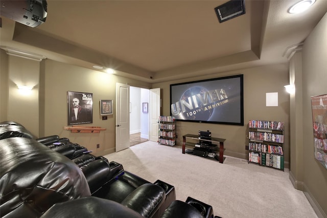 home theater room with light colored carpet, visible vents, and baseboards