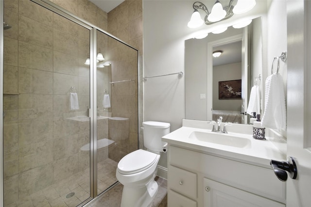 bathroom featuring vanity, a shower stall, and toilet