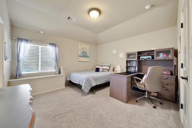 bedroom featuring light colored carpet, visible vents, lofted ceiling, and baseboards