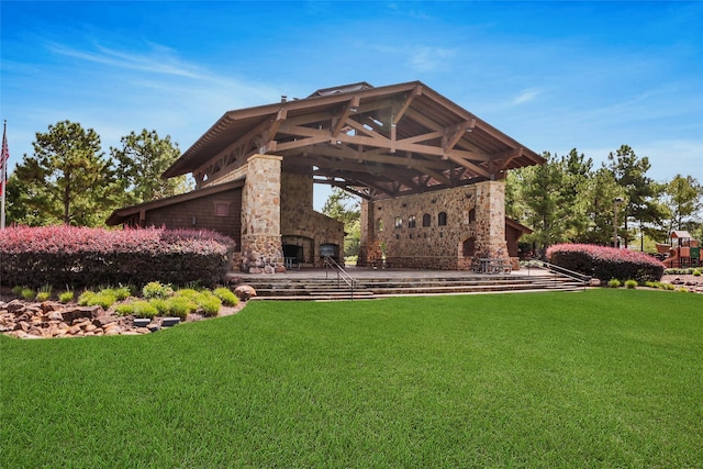 view of yard with an outdoor stone fireplace