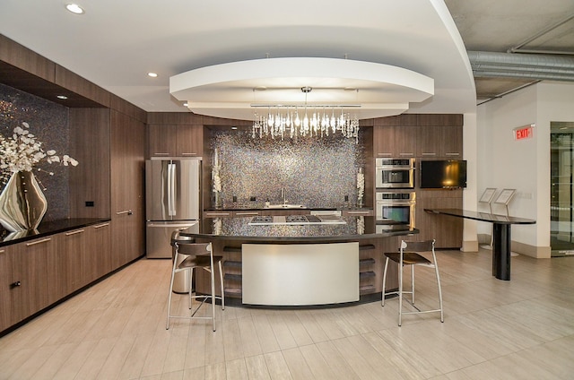 bar featuring pendant lighting, a notable chandelier, recessed lighting, backsplash, and appliances with stainless steel finishes