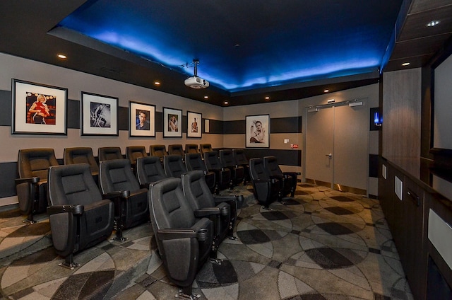 home theater room with recessed lighting and a raised ceiling