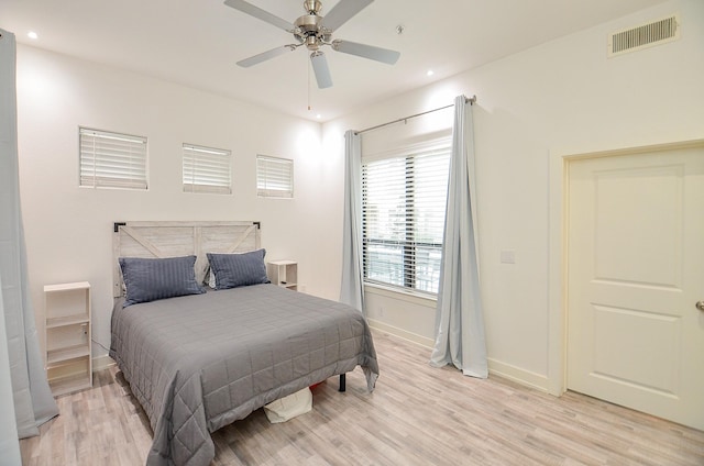 bedroom with ceiling fan, recessed lighting, visible vents, baseboards, and light wood finished floors