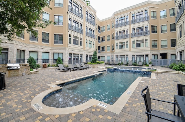 pool featuring area for grilling, a patio area, grilling area, and fence