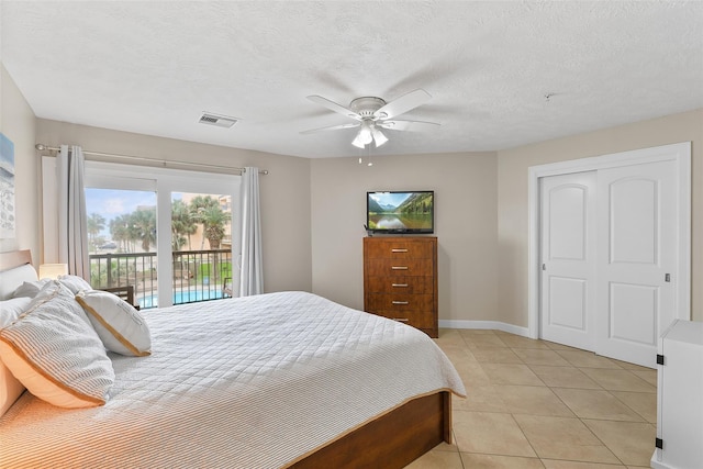 bedroom with access to exterior, visible vents, light tile patterned flooring, ceiling fan, and a textured ceiling