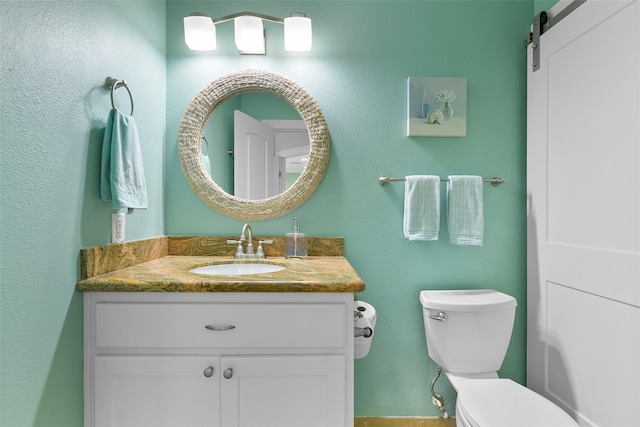 bathroom with toilet and vanity