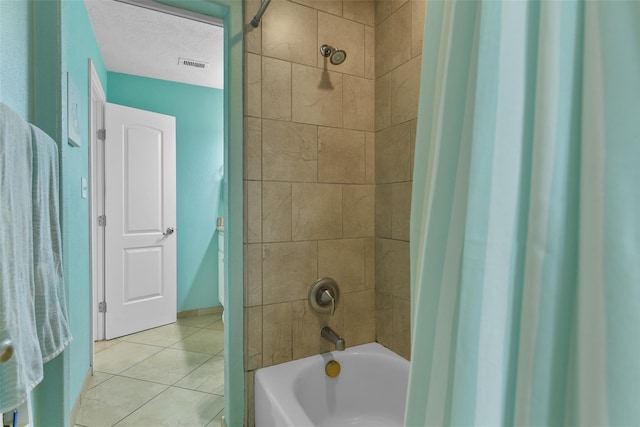 full bathroom with a textured ceiling, shower / tub combination, visible vents, and tile patterned floors