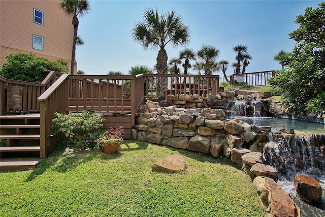 view of yard with stairs and a deck