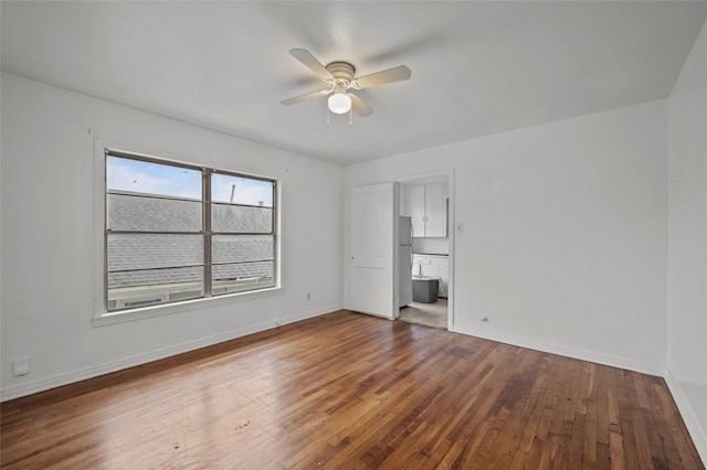 unfurnished room with ceiling fan, baseboards, and dark wood-style flooring