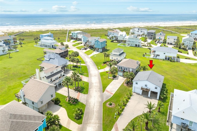 birds eye view of property with a water view, a residential view, and a view of the beach