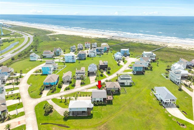 drone / aerial view with a water view, a residential view, and a beach view