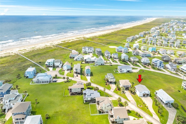 aerial view featuring a water view, a residential view, and a view of the beach