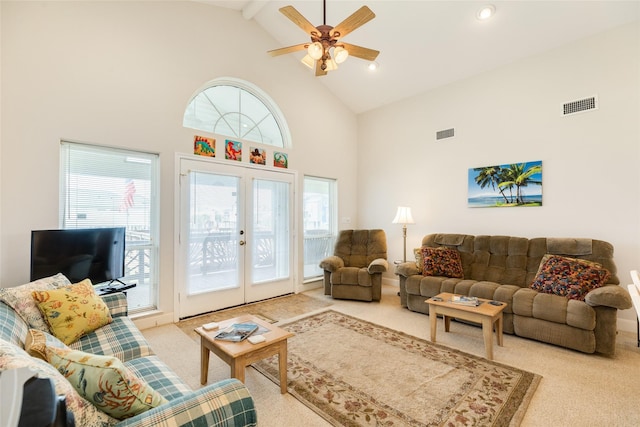 living room with light carpet, high vaulted ceiling, visible vents, and french doors