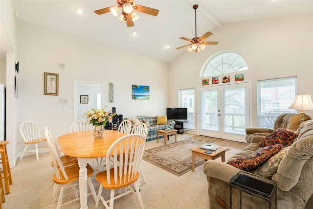 living area with light carpet, ceiling fan, beamed ceiling, french doors, and high vaulted ceiling