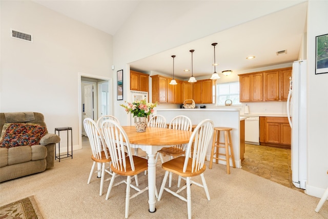 dining area featuring recessed lighting, visible vents, vaulted ceiling, and light carpet