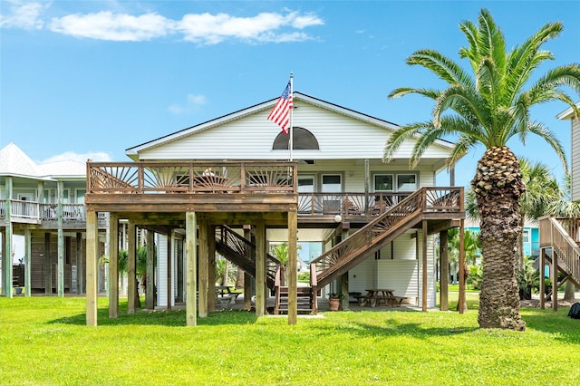 rear view of property featuring stairway and a lawn