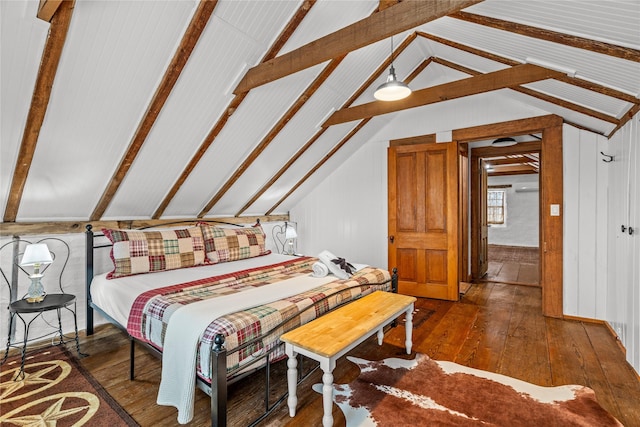 bedroom with vaulted ceiling with beams and dark wood-style flooring