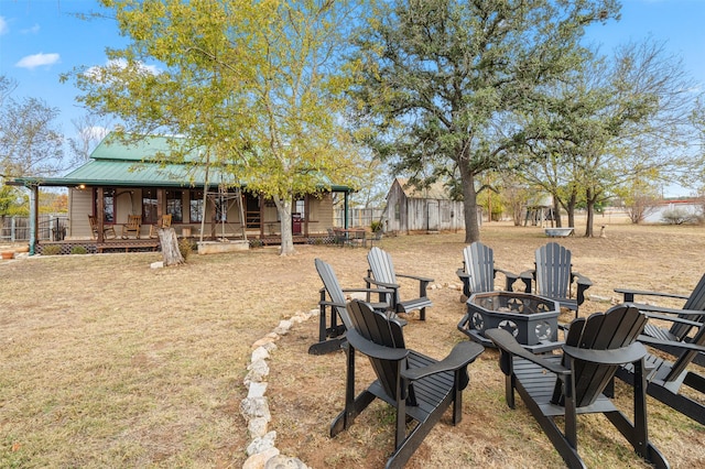 view of yard featuring an outdoor fire pit